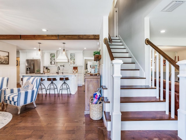 3724 Fawn Grove Ct, Land O Lakes, FL 34639 - staircase featuring recessed lighting, beamed ceiling, and hardwood / wood-style floors