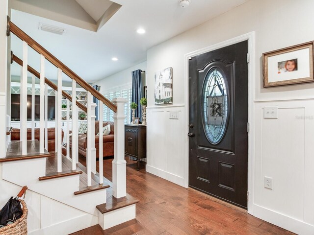3724 Fawn Grove Ct, Land O Lakes, FL 34639 - entryway with wood finished floors, a decorative wall, plenty of natural light, stairs, and a wainscoted wall