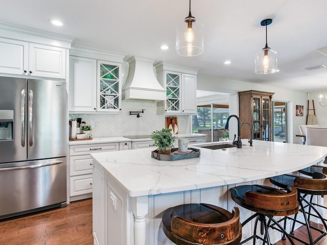 3724 Fawn Grove Ct, Land O Lakes, FL 34639 - kitchen with stainless steel fridge with ice dispenser, custom range hood, white cabinetry, a sink, and recessed lighting