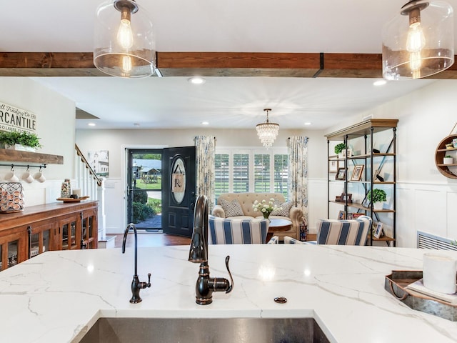 3724 Fawn Grove Ct, Land O Lakes, FL 34639 - kitchen with beamed ceiling, a sink, decorative light fixtures, recessed lighting, and a wainscoted wall