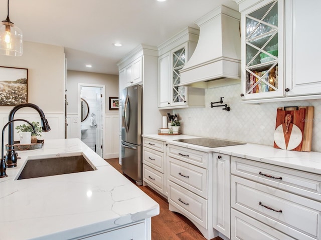 3724 Fawn Grove Ct, Land O Lakes, FL 34639 - kitchen with freestanding refrigerator, custom range hood, a sink, black electric stovetop, and dark wood-type flooring