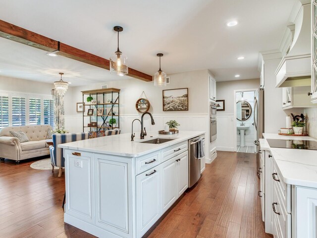 3724 Fawn Grove Ct, Land O Lakes, FL 34639 - kitchen featuring a sink, appliances with stainless steel finishes, wainscoting, white cabinetry, and beam ceiling