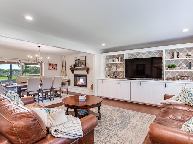 3724 Fawn Grove Ct, Land O Lakes, FL 34639 - living area with wood finished floors, a chandelier, a fireplace, and recessed lighting