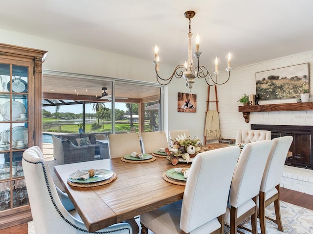 3724 Fawn Grove Ct, Land O Lakes, FL 34639 - dining room featuring a chandelier, wood finished floors, and a brick fireplace