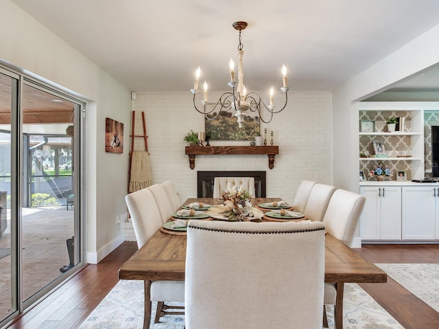 3724 Fawn Grove Ct, Land O Lakes, FL 34639 - dining space featuring a chandelier, dark wood finished floors, and brick wall