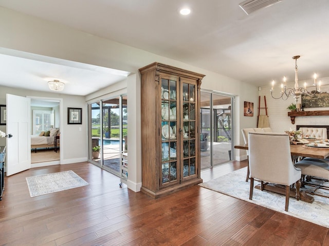 3724 Fawn Grove Ct, Land O Lakes, FL 34639 - dining space with a chandelier, wood finished floors, and baseboards