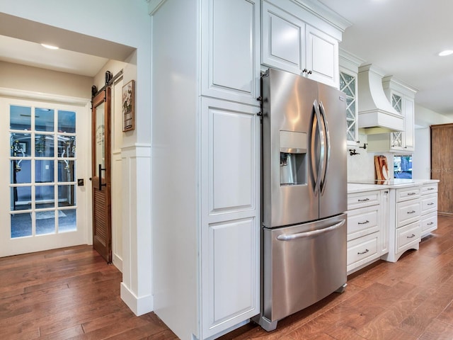 3724 Fawn Grove Ct, Land O Lakes, FL 34639 - kitchen featuring stainless steel fridge, custom exhaust hood, a barn door, wood finished floors, and recessed lighting