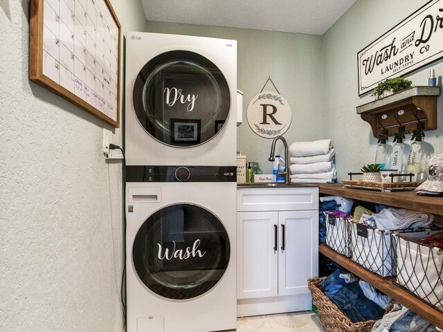 3724 Fawn Grove Ct, Land O Lakes, FL 34639 - laundry room with stacked washing machine and dryer, cabinet space, and a textured wall