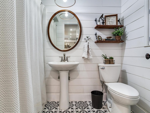 3724 Fawn Grove Ct, Land O Lakes, FL 34639 - full bathroom with toilet, a shower with shower curtain, tile patterned flooring, and wood walls