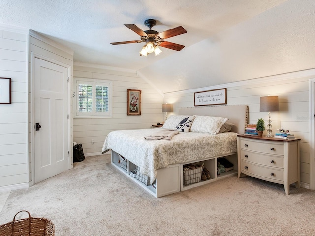 3724 Fawn Grove Ct, Land O Lakes, FL 34639 - bedroom featuring light carpet, wooden walls, ceiling fan, lofted ceiling, and a textured ceiling