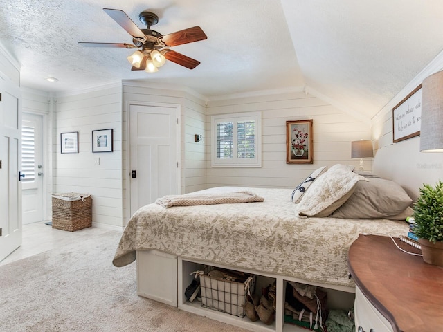 3724 Fawn Grove Ct, Land O Lakes, FL 34639 - bedroom featuring a textured ceiling, lofted ceiling, wooden walls, ceiling fan, and light carpet