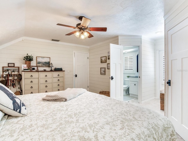 3724 Fawn Grove Ct, Land O Lakes, FL 34639 - bedroom with ornamental molding, connected bathroom, wooden walls, a ceiling fan, and a textured ceiling