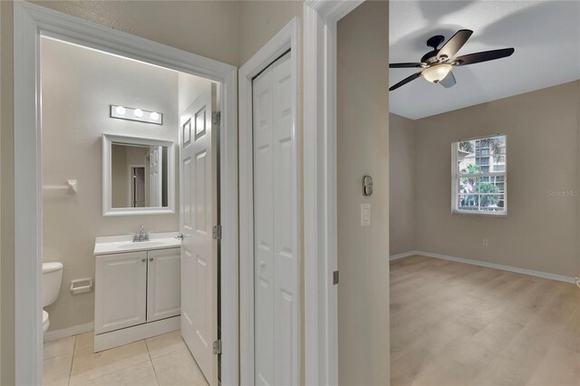 530 S Gulfview Blvd Unit 203, Clearwater Beach, FL 33767 - bathroom featuring vanity, toilet, a closet, a ceiling fan, and baseboards