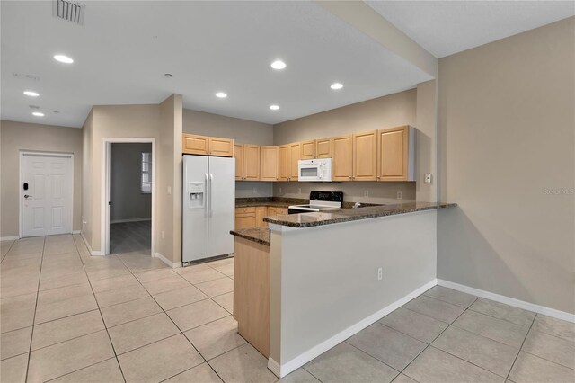 530 S Gulfview Blvd Unit 203, Clearwater Beach, FL 33767 - kitchen featuring white appliances, light brown cabinetry, baseboards, dark stone countertops, and light tile patterned flooring