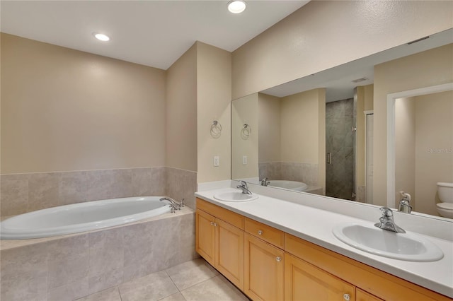 530 S Gulfview Blvd Unit 203, Clearwater Beach, FL 33767 - bathroom with toilet, a garden tub, tile patterned floors, a shower stall, and double vanity