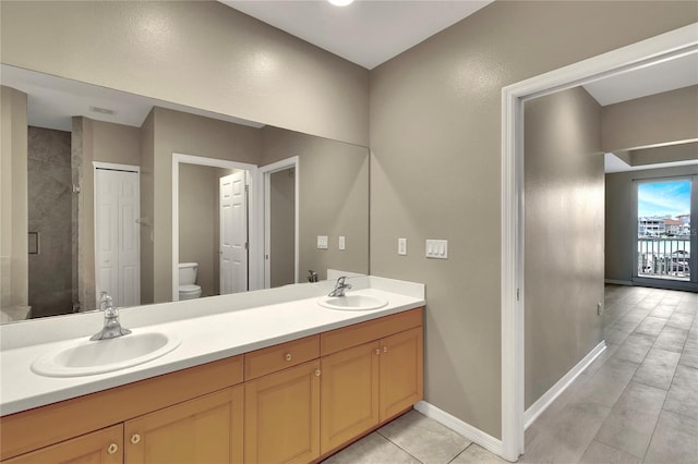 530 S Gulfview Blvd Unit 203, Clearwater Beach, FL 33767 - bathroom featuring toilet, double vanity, a stall shower, and baseboards