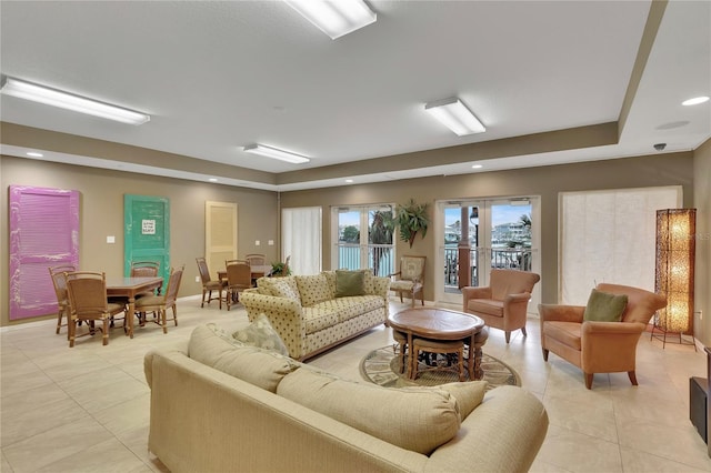 530 S Gulfview Blvd Unit 203, Clearwater Beach, FL 33767 - living room featuring light tile patterned floors, a tray ceiling, recessed lighting, and baseboards