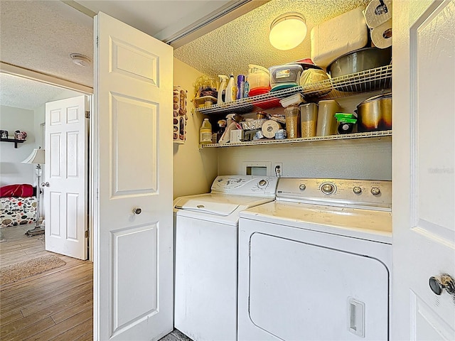 5920 80th St N Unit 406, Saint Petersburg, FL 33709 - washroom featuring separate washer and dryer, a textured ceiling, and wood finished floors