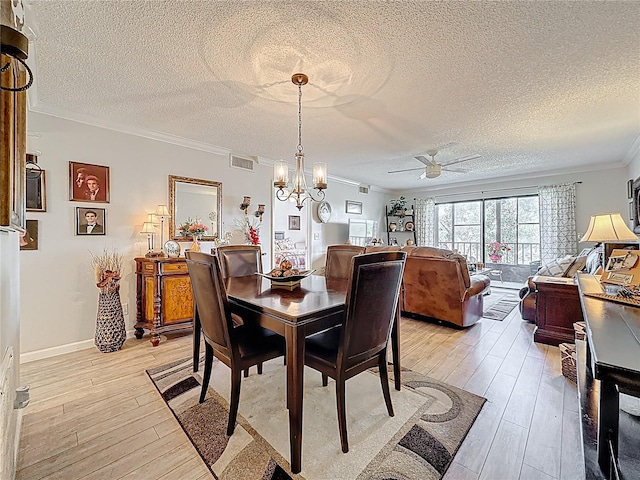 5920 80th St N Unit 406, Saint Petersburg, FL 33709 - dining area featuring crown molding, a textured ceiling, ceiling fan, light wood-style flooring, and a chandelier