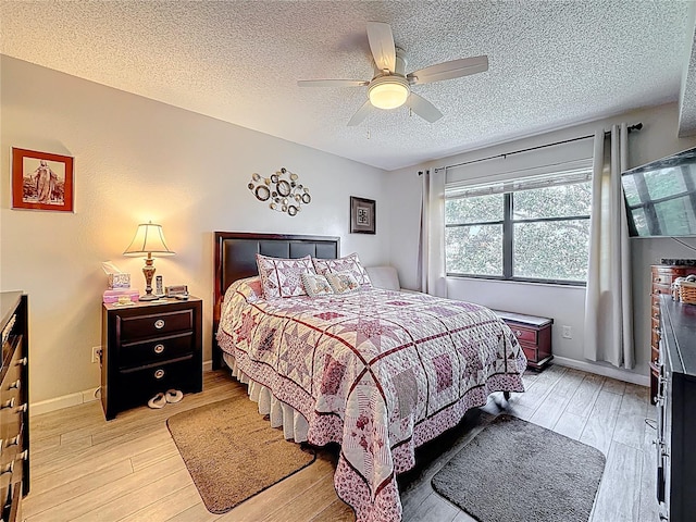 5920 80th St N Unit 406, Saint Petersburg, FL 33709 - bedroom featuring light wood finished floors, a textured ceiling, ceiling fan, and baseboards
