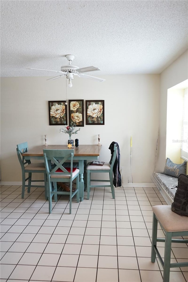 413 Lake Point Ct Unit 4B, Sun City Center, FL 33573 - dining space with a textured ceiling, a ceiling fan, baseboards, and light tile patterned floors