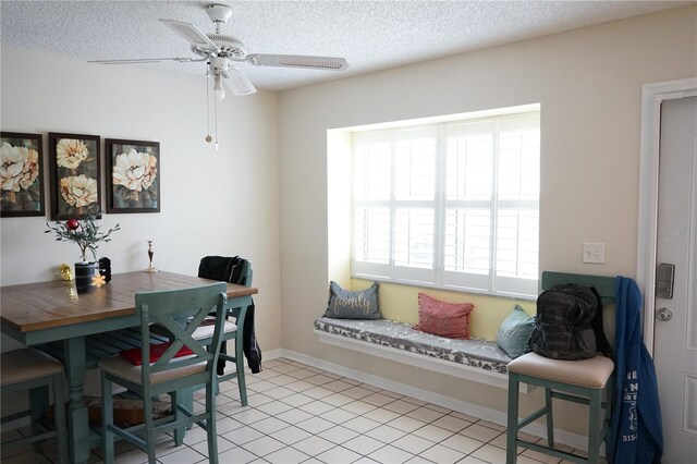 413 Lake Point Ct Unit 4B, Sun City Center, FL 33573 - dining room featuring a ceiling fan, a textured ceiling, and baseboards