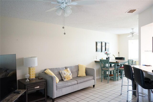 413 Lake Point Ct Unit 4B, Sun City Center, FL 33573 - living room with ceiling fan, light tile patterned floors, and a textured ceiling