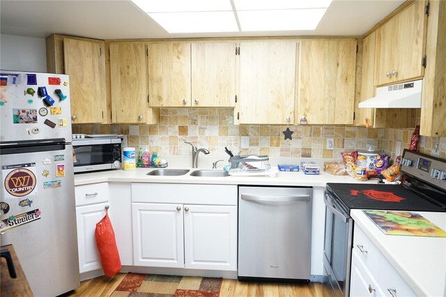 413 Lake Point Ct Unit 4B, Sun City Center, FL 33573 - kitchen with stainless steel appliances, under cabinet range hood, a sink, light countertops, and tasteful backsplash