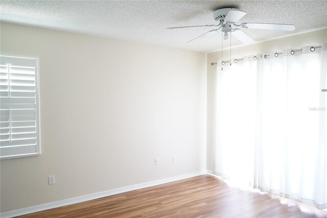 413 Lake Point Ct Unit 4B, Sun City Center, FL 33573 - unfurnished room featuring ceiling fan, wood finished floors, a textured ceiling, and baseboards