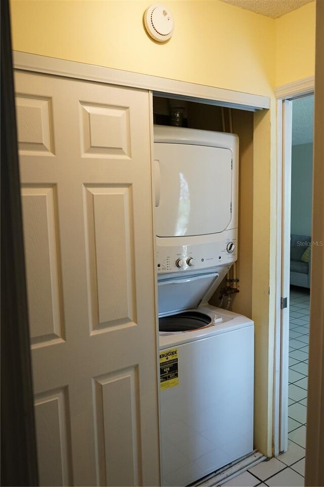 413 Lake Point Ct Unit 4B, Sun City Center, FL 33573 - laundry area with stacked washer / drying machine and light tile patterned floors
