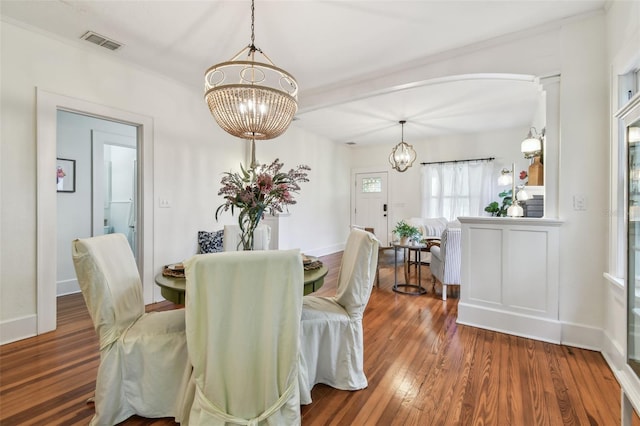 848 9th Ave S, Saint Petersburg, FL 33701 - dining space with a chandelier, wood finished floors, and baseboards
