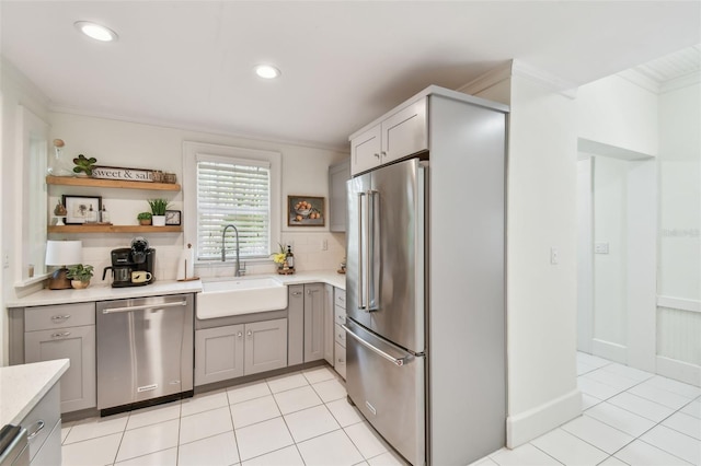848 9th Ave S, Saint Petersburg, FL 33701 - kitchen featuring stainless steel appliances, a sink, ornamental molding, gray cabinetry, and light countertops