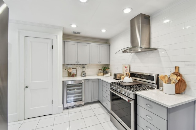 848 9th Ave S, Saint Petersburg, FL 33701 - kitchen featuring gray cabinets, beverage cooler, stainless steel gas range oven, island range hood, and crown molding