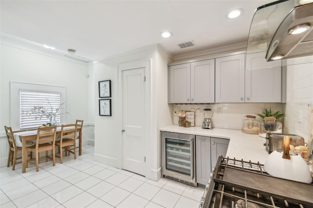 848 9th Ave S, Saint Petersburg, FL 33701 - kitchen featuring beverage cooler, crown molding, gray cabinets, tasteful backsplash, and light countertops