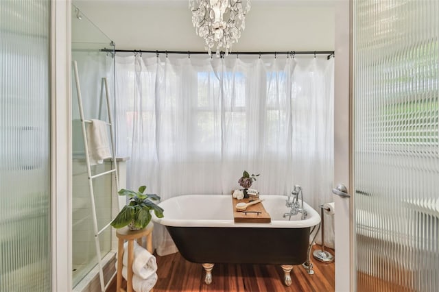 848 9th Ave S, Saint Petersburg, FL 33701 - bathroom featuring wood finished floors, a chandelier, a soaking tub, and a stall shower