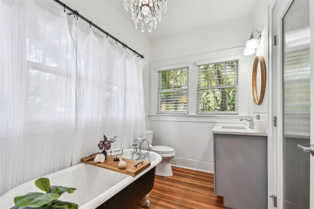 848 9th Ave S, Saint Petersburg, FL 33701 - full bathroom with a freestanding tub, vanity, toilet, wood finished floors, and a chandelier