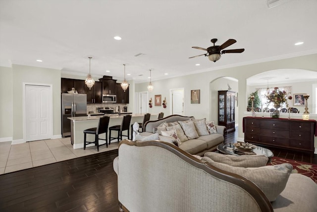 679 Challice Dr, Spring Hill, FL 34609 - living room featuring arched walkways, light wood-style floors, a ceiling fan, recessed lighting, and baseboards