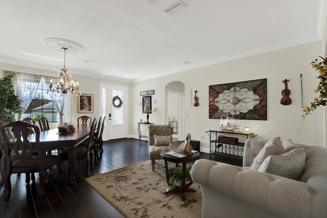 679 Challice Dr, Spring Hill, FL 34609 - living room with arched walkways, healthy amount of natural light, ornamental molding, a chandelier, and dark wood finished floors