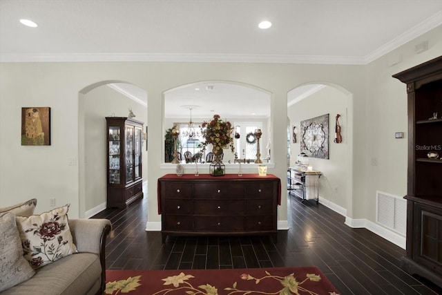679 Challice Dr, Spring Hill, FL 34609 - living area featuring arched walkways, dark wood finished floors, baseboards, crown molding, and recessed lighting