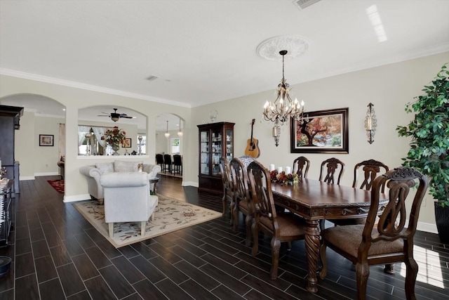 679 Challice Dr, Spring Hill, FL 34609 - dining room with arched walkways, baseboards, a chandelier, and crown molding