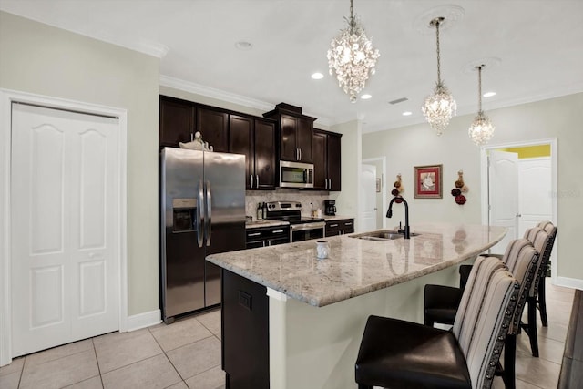 679 Challice Dr, Spring Hill, FL 34609 - kitchen featuring stainless steel appliances, a sink, a chandelier, a kitchen bar, and backsplash