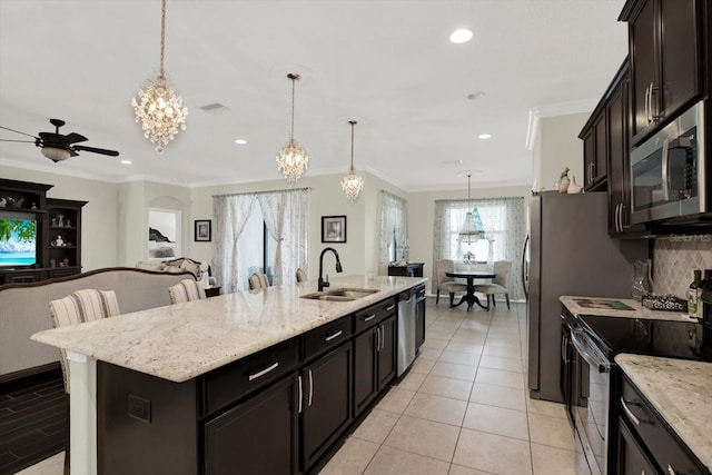 679 Challice Dr, Spring Hill, FL 34609 - kitchen with electric range, a sink, a chandelier, open floor plan, and a kitchen island with sink