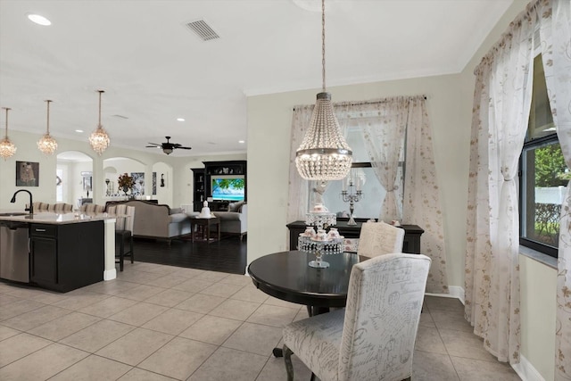 679 Challice Dr, Spring Hill, FL 34609 - dining space with a chandelier, light tile patterned floors, a ceiling fan, arched walkways, and recessed lighting