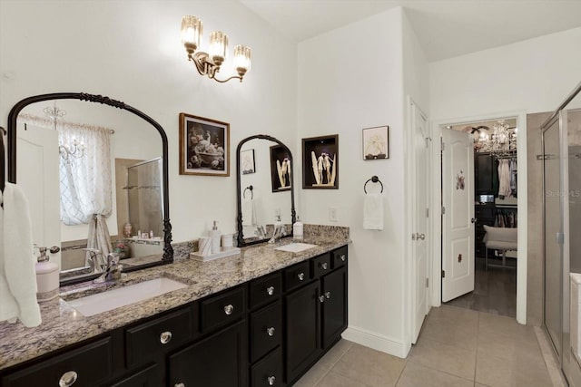 679 Challice Dr, Spring Hill, FL 34609 - bathroom featuring a chandelier, tile patterned flooring, double vanity, and a shower with door