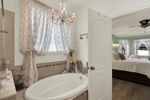 679 Challice Dr, Spring Hill, FL 34609 - full bathroom with a garden tub, a chandelier, ensuite bath, wood finished floors, and ceiling fan