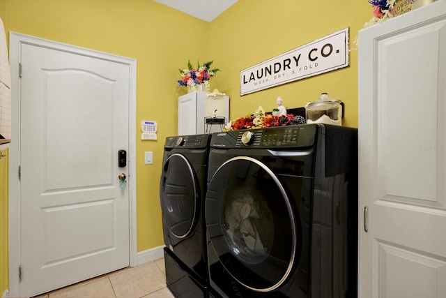 679 Challice Dr, Spring Hill, FL 34609 - laundry room with cabinet space, separate washer and dryer, light tile patterned flooring, and baseboards