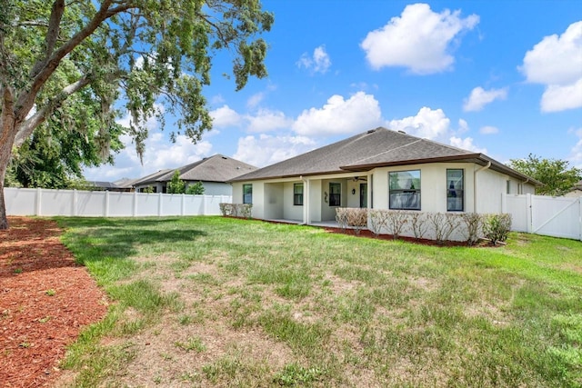679 Challice Dr, Spring Hill, FL 34609 - back of property featuring stucco siding, a ceiling fan, a gate, and a shingled roof