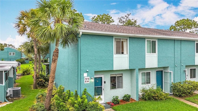 147 114th Ave NE Unit 147, Saint Petersburg, FL 33716 - view of front of property featuring central AC unit, stucco siding, and a front yard