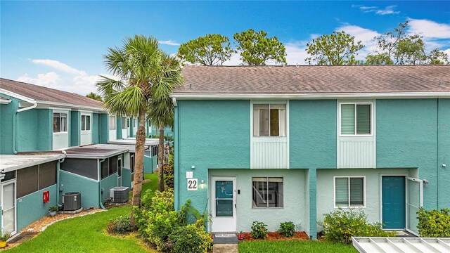 147 114th Ave NE Unit 147, Saint Petersburg, FL 33716 - view of front of property featuring stucco siding, central AC, and a front lawn