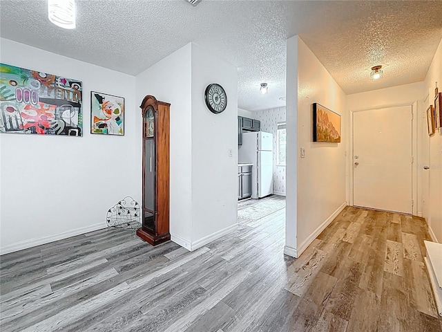 147 114th Ave NE Unit 147, Saint Petersburg, FL 33716 - hall with wood finished floors, a textured ceiling, and baseboards